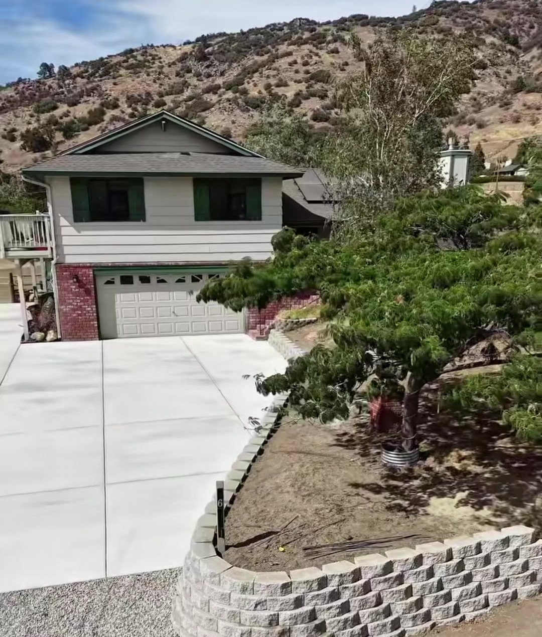 A finished driveway with a retaining wall alongside